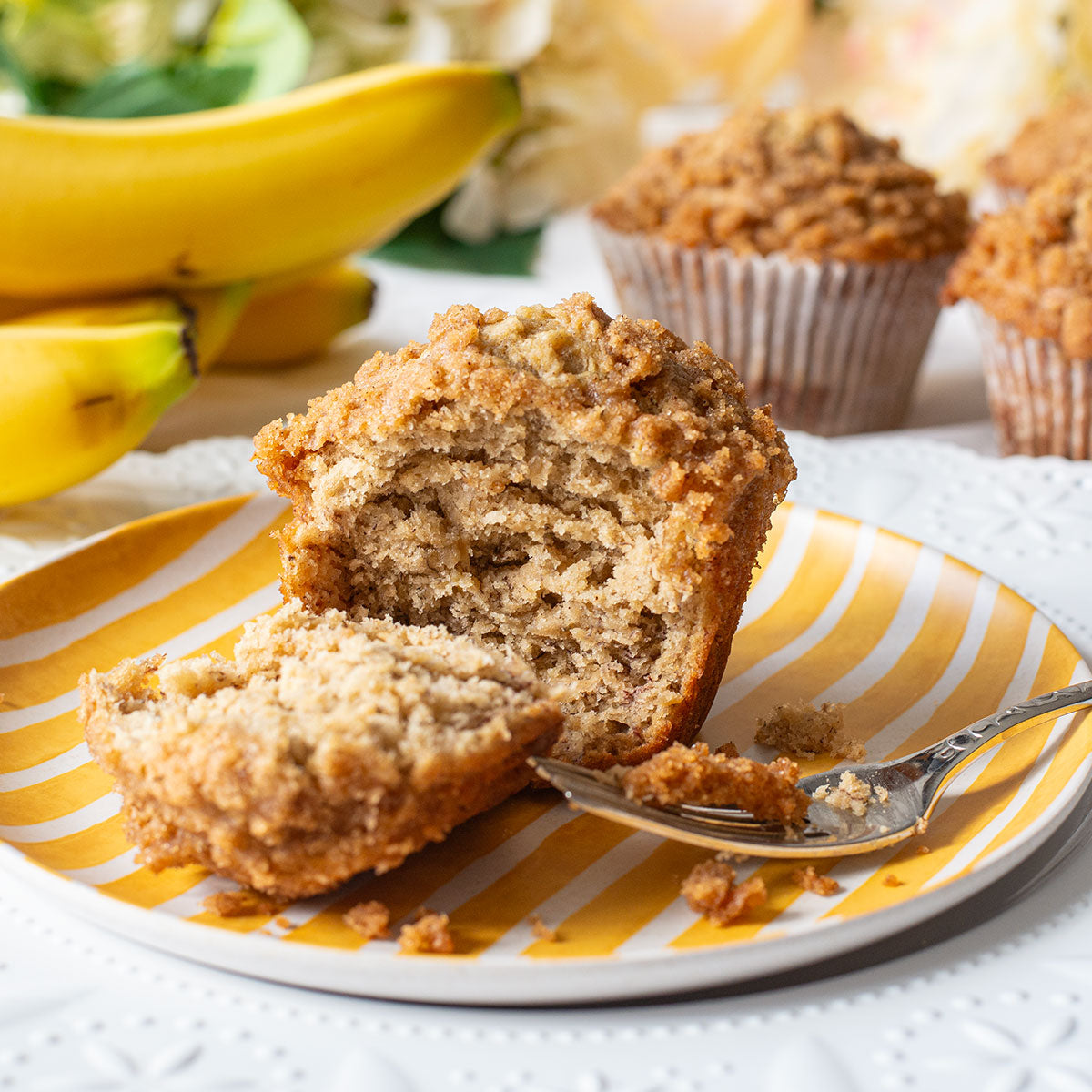 A tempting assortment of Banana Crumb Muffins, capturing their homey and inviting appeal with their jumbo size, ripe banana goodness, and the sweet touch of the brown sugar and cinnamon crumb on top.