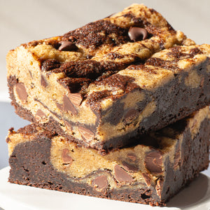 An up-close photo of freshly baked Brookies, highlighting the delightful contrast between the cookie and brownie layers, offering a deliciously casual dessert experience.