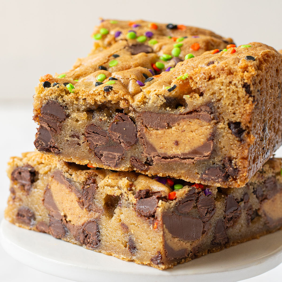 Layered Chocolate Chip Cookie Bars with Assorted Candy and Festive Sprinkles