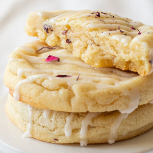 Close-up of Champagne & Roses Cookies with delicate rose petal garnish, showcasing their refined flavor profile.