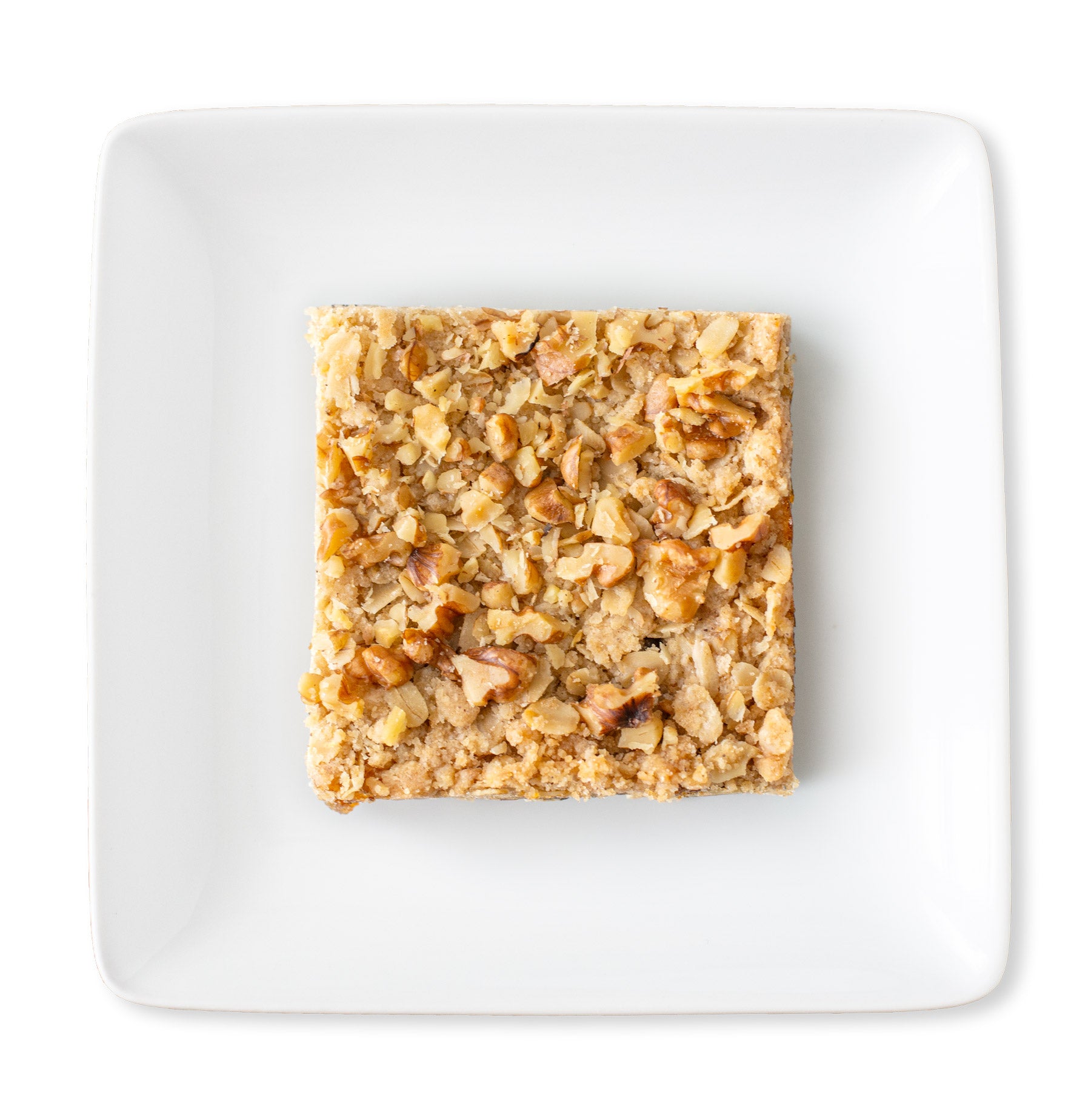 An overhead view of a Figgy Walnut Bar, highlighting the walnut crumble topping and the golden buttery brown sugar and oat crust.