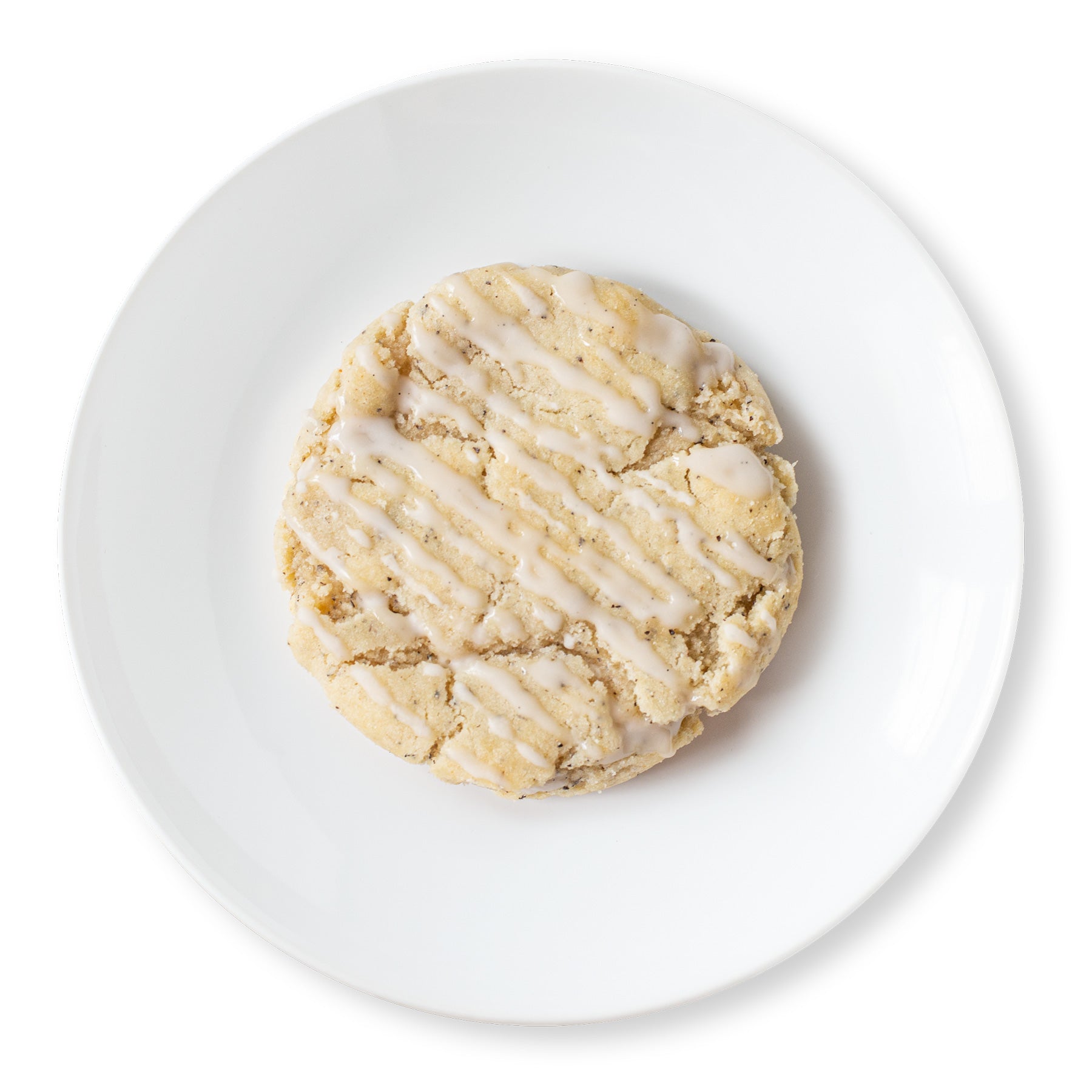 A close-up image of a London Fog Latte Cookie, showing its golden-brown surface with a drizzle of vanilla bean glaze.