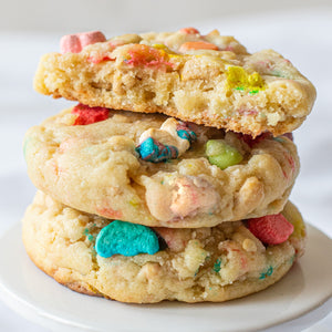 Stack of three Lots 'O Luck cookies, one broken open to show the cereal bits and white chocolate chips inside.