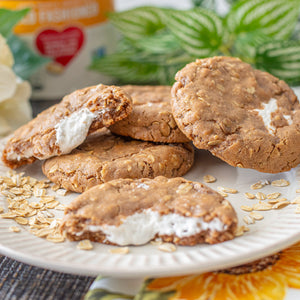 Oatmeal Cream Pie Cookies on a plate with oats scattered around—pure homemade goodness in every bite.