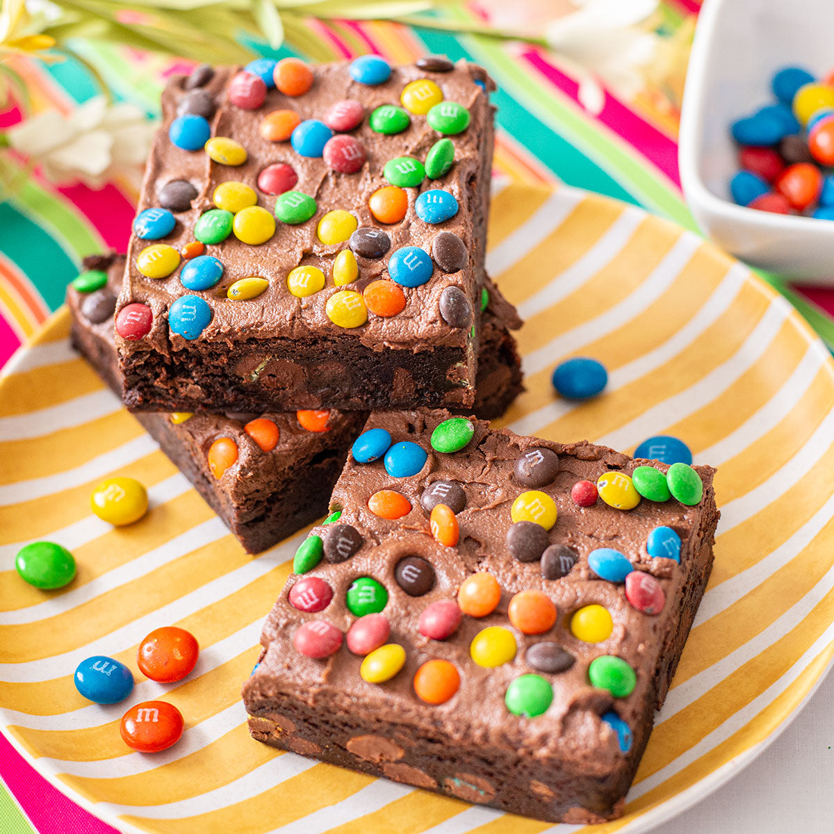 Frosted M&M Brownies 🤩🌈 are you team fudgy or cakey